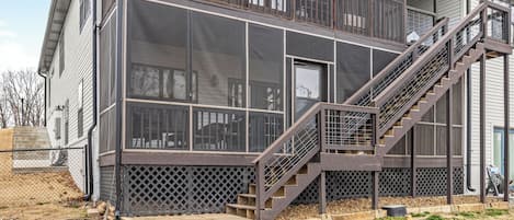 A two-story building with a metal staircase and a large windowed facade.