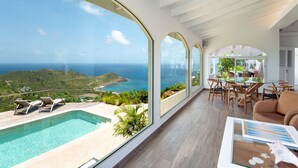 A modern interior with a pool, dining area, and a view of the ocean. - Villa Ocean Vibes (2 bedrooms) (San Bartolomé)