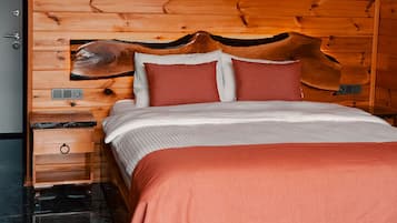 A wooden bed with a headboard, a nightstand, and a marble floor.
