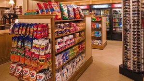 A grocery store with aisles stocked with snacks, cereals, and other food items. - Orlando | Pool & Disney Access | 2BR Suite (Lake Buena Vista)
