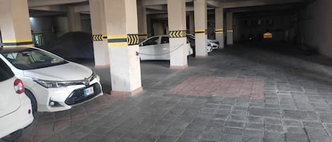A multi-level parking garage with several cars parked.