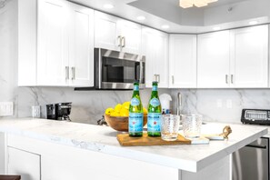 The recently updated white cabinets and stainless appliances give the kitchen a clean, well-appointed feel - Valley Isle Villas | Oceanfront Studio | Car Incl. w/ 6+ Nights | VIR-107 by KBM (Lahaina)