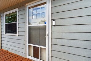 A house with a front door, a window, and a security camera.