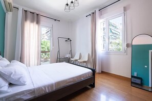 A bedroom with a bed, a wardrobe, a mirror, and a window. - S homes | Athens · Retro-Modern 2BR · Attiki Metro (Athens)