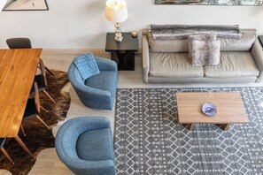 A modern living room with a sofa, two armchairs, a coffee table, and a rug. - Ski In/Out Sunset Luxury: Etta Place Too 115 at the base of Lift 7 (Telluride)