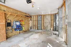 A room under construction with exposed wooden framing, a concrete floor, and construction tools. - Sully & Sonshine | 3 BR Near Sullivan's Island (Mount Pleasant)