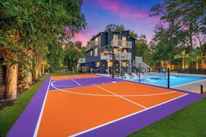 A basketball court with a pool and a multi-story building in the background. - Entire home in Seminole, Florida, United States (Seminole)