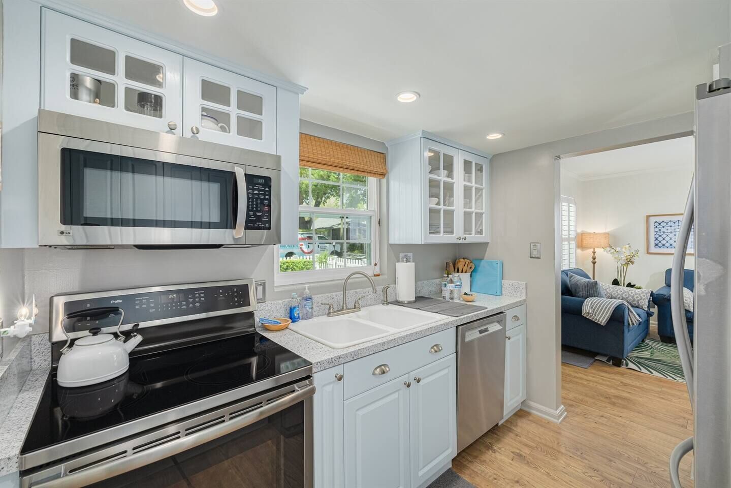 A modern kitchen with a built-in microwave, oven, and dishwasher.