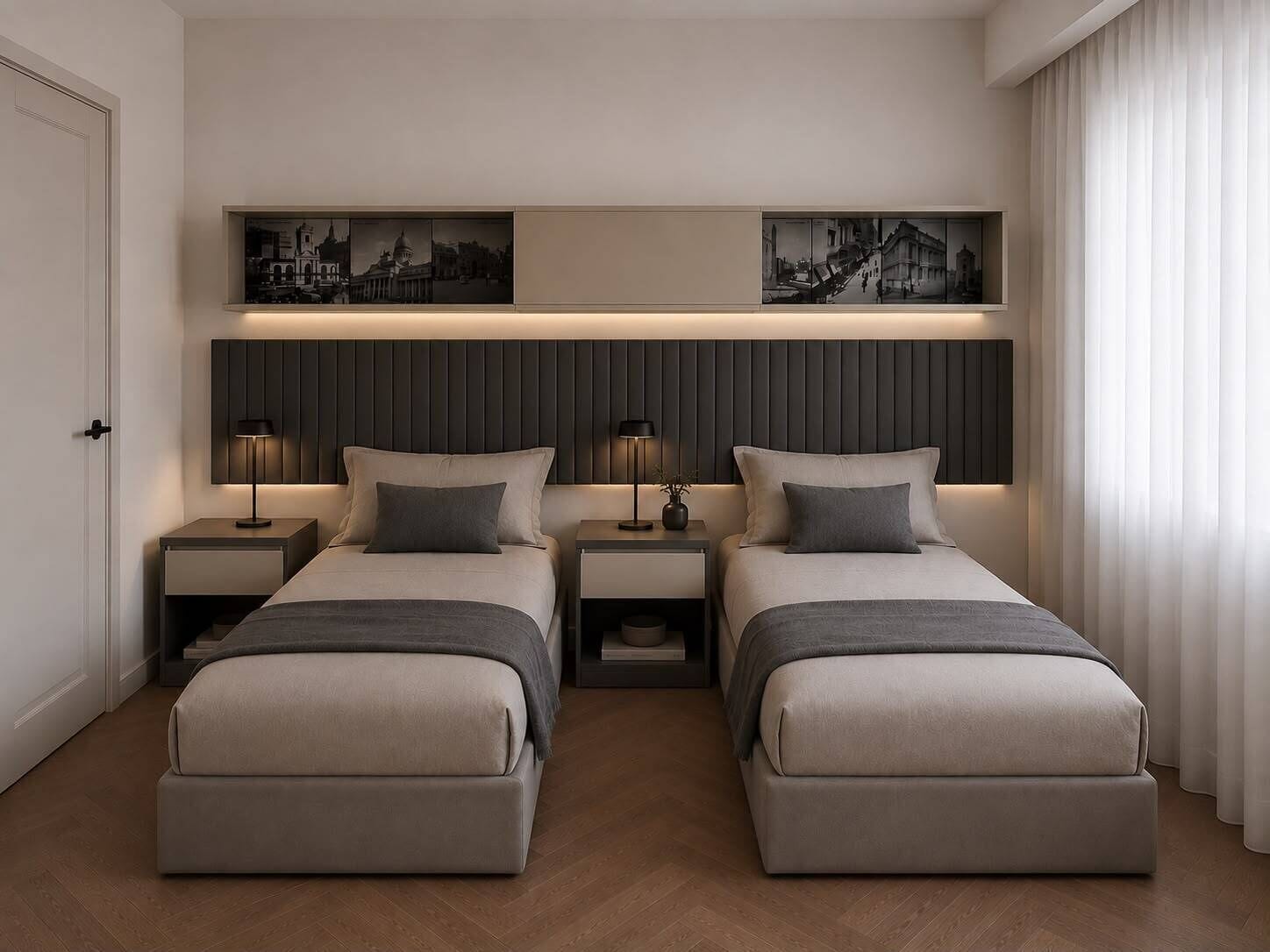 A hotel room with two beds, nightstands, a wall-mounted shelf with artwork, and a door.