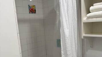 Shower, hair dryer, towels, shampoo