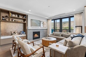 A modern living room with a fireplace, a sofa set, a coffee table, and a bookshelf. - Frontgate | Luxury Condo W/Resort Amenities (Avon)