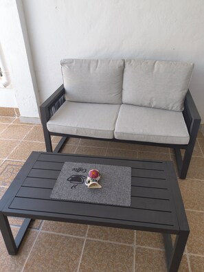 A black metal table with a placemat and a decorative item on it. - Tranquil oasis in Costa Blanca (VC)