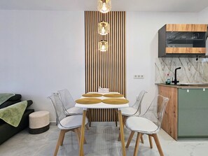 A modern kitchen with a built-in oven, a wooden cabinet, and a marble backsplash. - Tranquil oasis in Costa Blanca (VC)