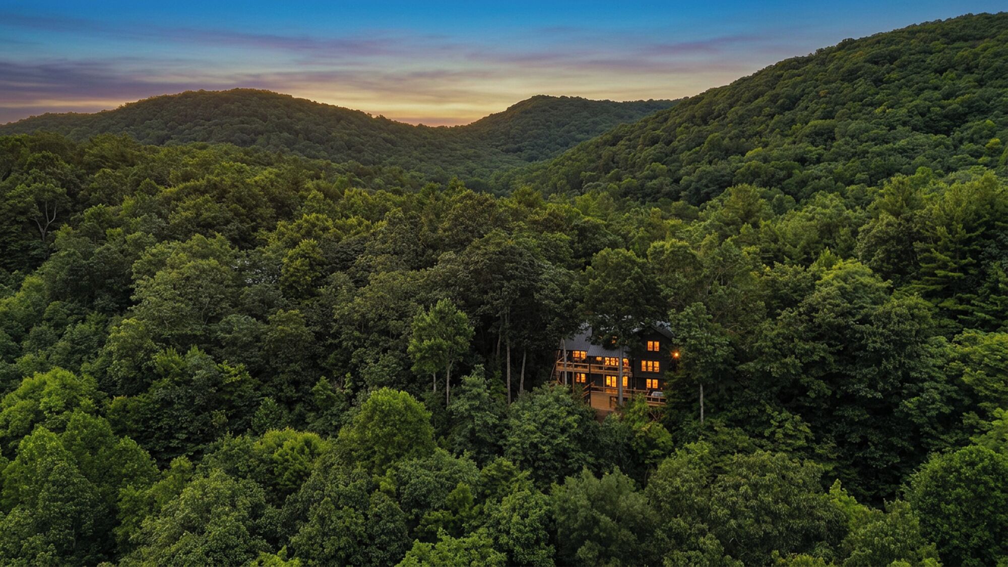 A cabin surrounded by dense forest with a clear view of the surrounding hills.