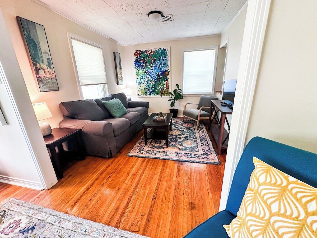A living room with a sofa, coffee table, and a rug.