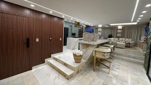 A modern interior with a marble staircase, a seating area, and a kitchen. - Exclusive penthouse rooftop pool, luxury living and beach (Cartagena de Indias)
