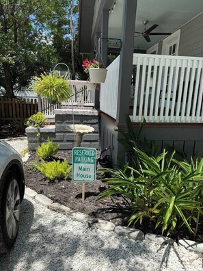 A sign indicating reserved parking for the main house, a white fence, and a car parked in front. - 2BR/2B Home-Walk to St. Aug (St. Augustine)