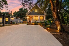 A two-story house with a front porch, a basketball hoop, and a driveway leading to the entrance. - St. Augustine with Private Pool Near Downtown (St. Augustine)