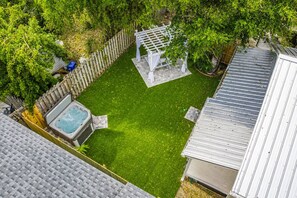 A backyard with a hot tub, a pergola, and a fenced area. - St. Augustine | Hot Tub | Parking | Walk Downtown (St. Augustine)