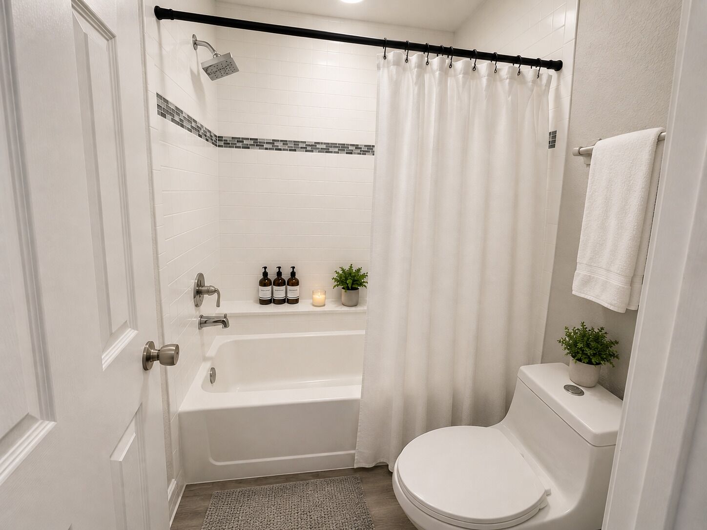 A bathroom with a bathtub, toilet, shower, and a curtain.