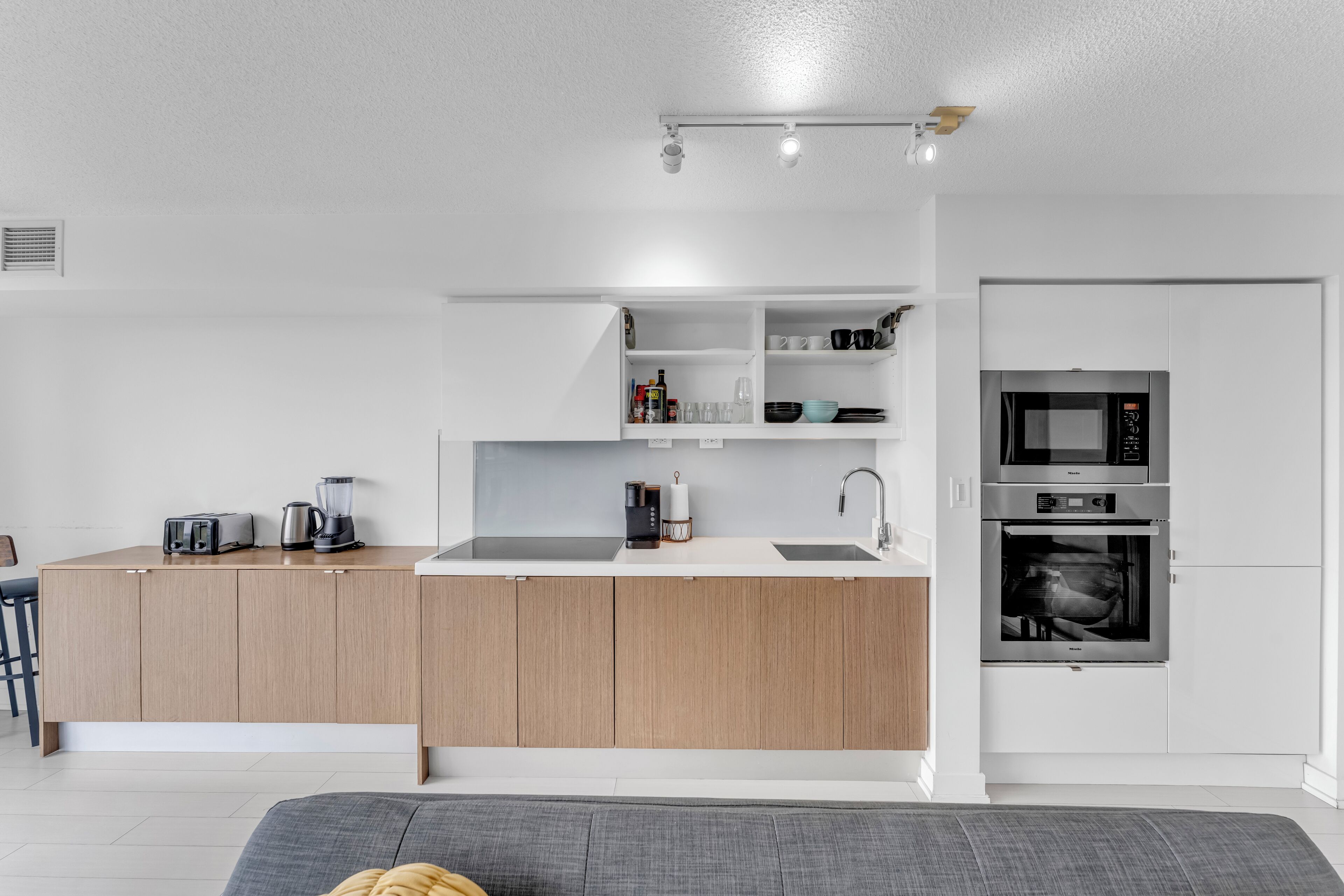 A modern kitchen with a central island, built-in appliances, and a minimalist design.