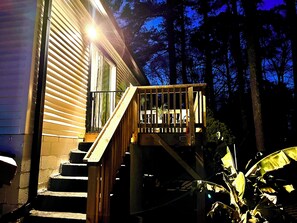 A wooden staircase leading to a deck with a railing, surrounded by trees. - House of Gems Relax & Unwind Beautiful Atlanta Home for Families & Groups (Atlanta)