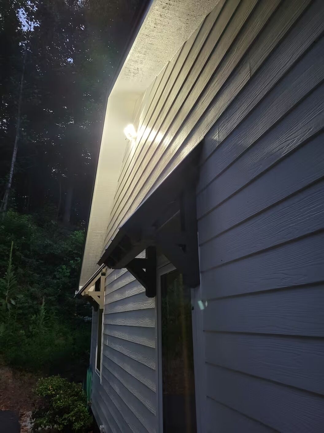 A house with a sloped roof and siding.