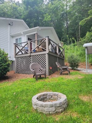 A house with a covered porch, a fire pit, and outdoor furniture. - Charming 2 bedroom, 2 bath cottage in the mountains of Clayton, Georgia. (Clayton)
