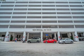 A multi-story parking garage with a sign reading '1200 Brickell Bay Drive.' - Brickell brand new unit 26th floor (Miami)