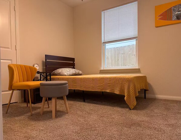 A bedroom with a bed, a chair, a small table, and a window. - Fast WiFi -3BR2BA Private Yard Work Crew Friendly (Willis)