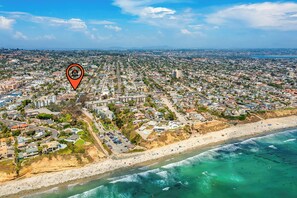 An aerial view of a coastal city with a beach, roads, and buildings. - The Tourmaline Beach House - Walk to Surf & Sand (San Diego)