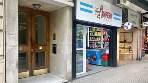 A storefront with a sign that reads 'Super Pampo' and a display of various packaged goods. - 157- Apt. with Great Location for 3 p. in Recoleta (Buenos Aires)