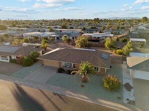 A residential area with houses, solar panels, and a clear sky. - Rolling Hills Haven | 3BR | Large Screened Patio | Fenced Yard | Sun City | Sleeps 6 (Sun City)