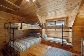 A cabin with two bunk beds, a window, and a ceiling fan. - Scenic Mountain Retreat Just Minutes from Boone (Boone)