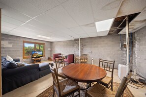 A room with a round wooden table, chairs, a sofa, and a television. - Scenic Mountain Retreat Just Minutes from Boone (Boone)