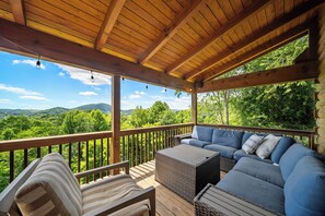 A covered outdoor seating area with a view of a mountainous landscape. - Scenic Mountain Retreat Just Minutes from Boone (Boone)