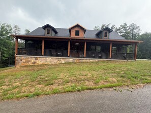 A two-story building with a stone foundation and a wooden upper structure.