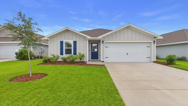 A single-story residential house with a front garage, a well-maintained lawn, and a small tree. - Owl's Head Haven 235-4 Bed House-Unfurnished (Freeport)