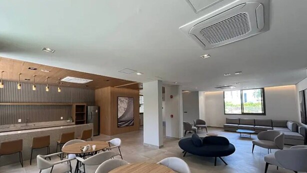 A modern interior with a dining area, seating, and a large window. - Apartamento com varanda - Pinheiros (São Paulo)