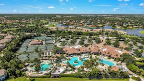 A resort with multiple swimming pools, tennis courts, and a large parking area. - Private Pool Villa | Players Club & Spa | Golf Views (Naples)