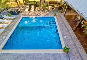 A rectangular swimming pool with a tiled deck surrounding it. - Heated Pool | Boat Parking | Outdoor Kitchen (Broken Bow)
