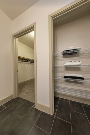 A hallway with a closet containing shelves and hangers. - Skyline-View, 2BR, 2.5Bt, Pool, Gym& Free Parking (Dallas)