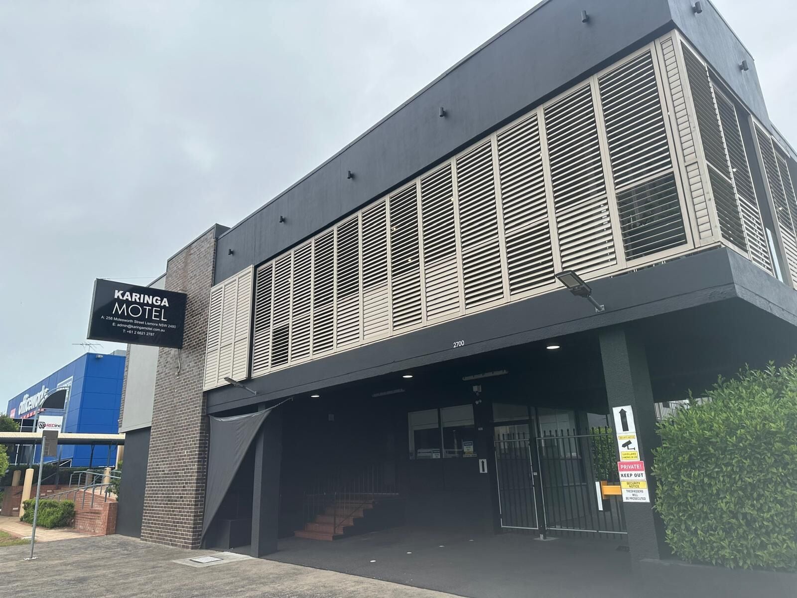A modern building with a sign for Karinga Motel.
