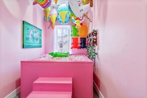 A pink room with a play area, a window, and a framed picture on the wall. - Pretty & Pink Unit w/ Ball Pit In Philly (Philadelphia)