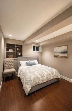 A bedroom with a bed, a chair, a shelf with plants, a window, and a painting on the wall. - Ocean Park 2BR Retreat South Surrey & Parking (Surrey)