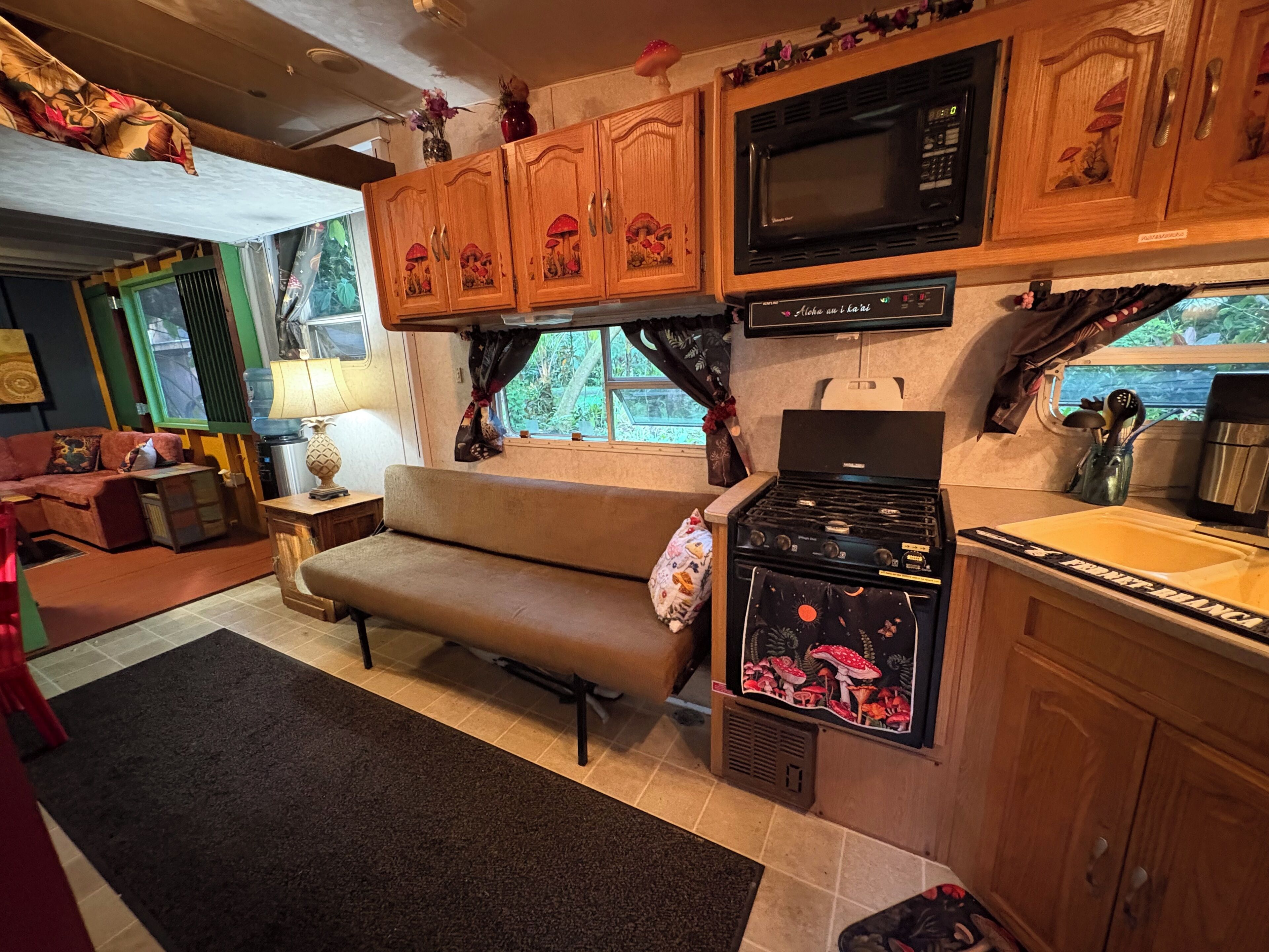 A compact living space with a kitchenette, a sofa, and a dining table.