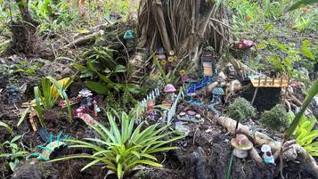 A garden with various plants and decorative elements.