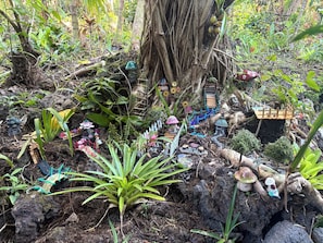 A garden with various plants and decorative elements.