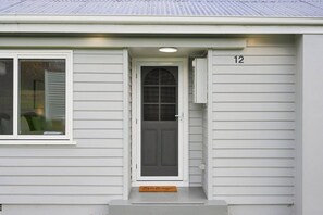 A house with a front door, a window, and a number '12' on the wall. - Modern 3BR Home Near Bellerive (Warrane)