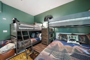 A bunk bed room with a ladder, a desk, and a chair. - Legacy Springs at Eagles Nest - hot tub, creek (Banner Elk)